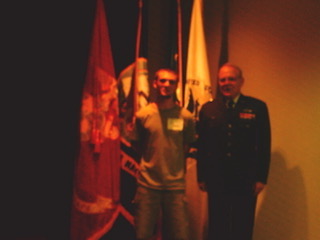 Me and my grandfather after he swore me in to the Army National Guard, standing next to the colors.